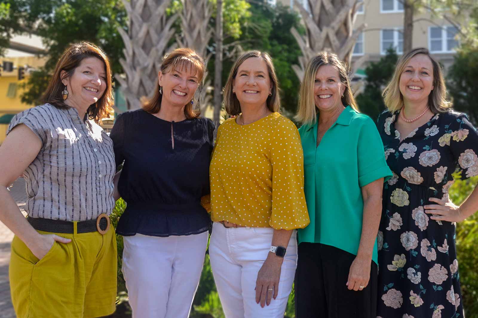 five women staff members posing for a group photo