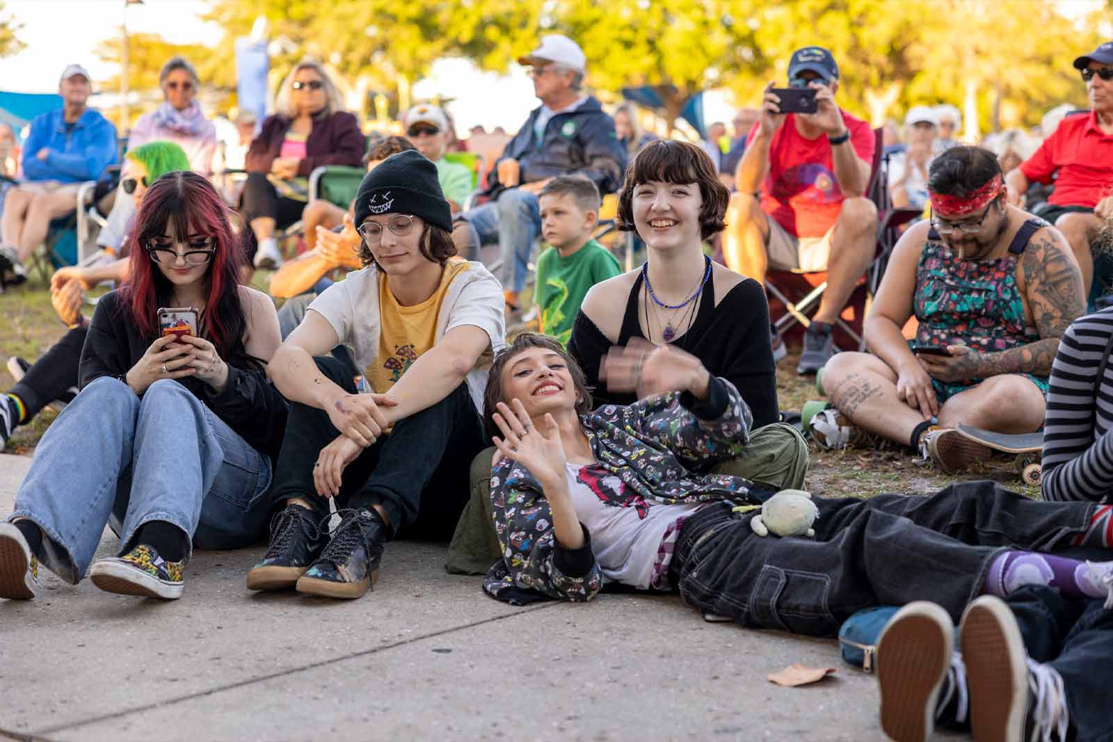 Young people in crowd listening to a live-music event.